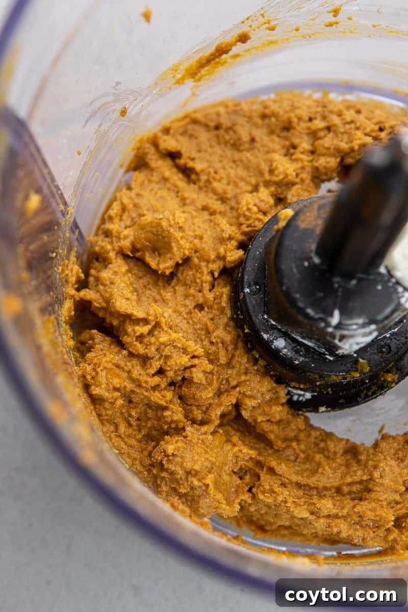 Close-up of the mixed pumpkin truffle dough in a food processor