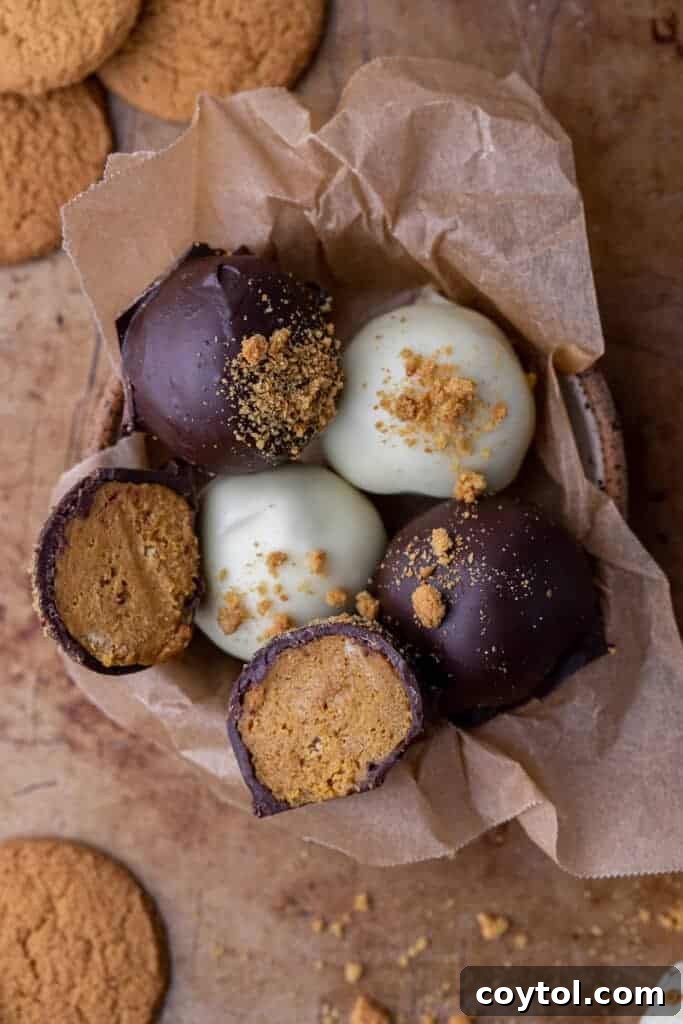 Overhead shot of white and dark chocolate-dipped pumpkin truffles on a serving platter