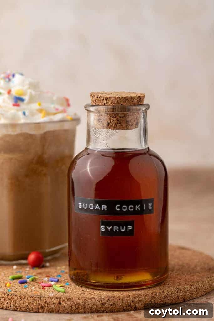 Homemade Starbucks Sugar Cookie Syrup in an elegant glass bottle, ready to be added to coffee or other drinks, representing cozy holiday flavors.