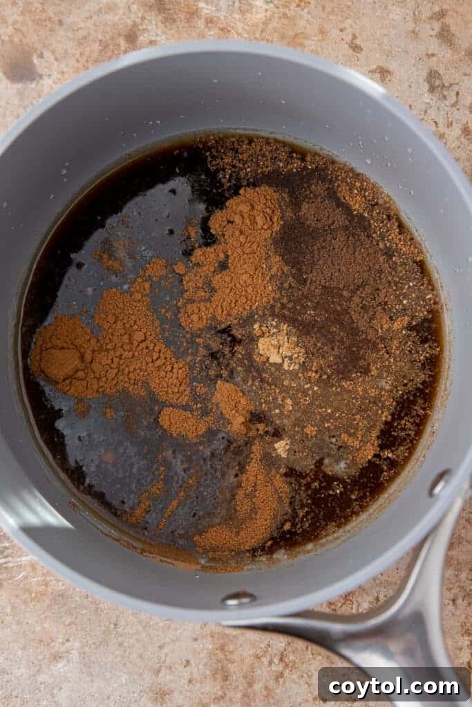 Spices, sugar, and water mixed in a small saucepan before simmering