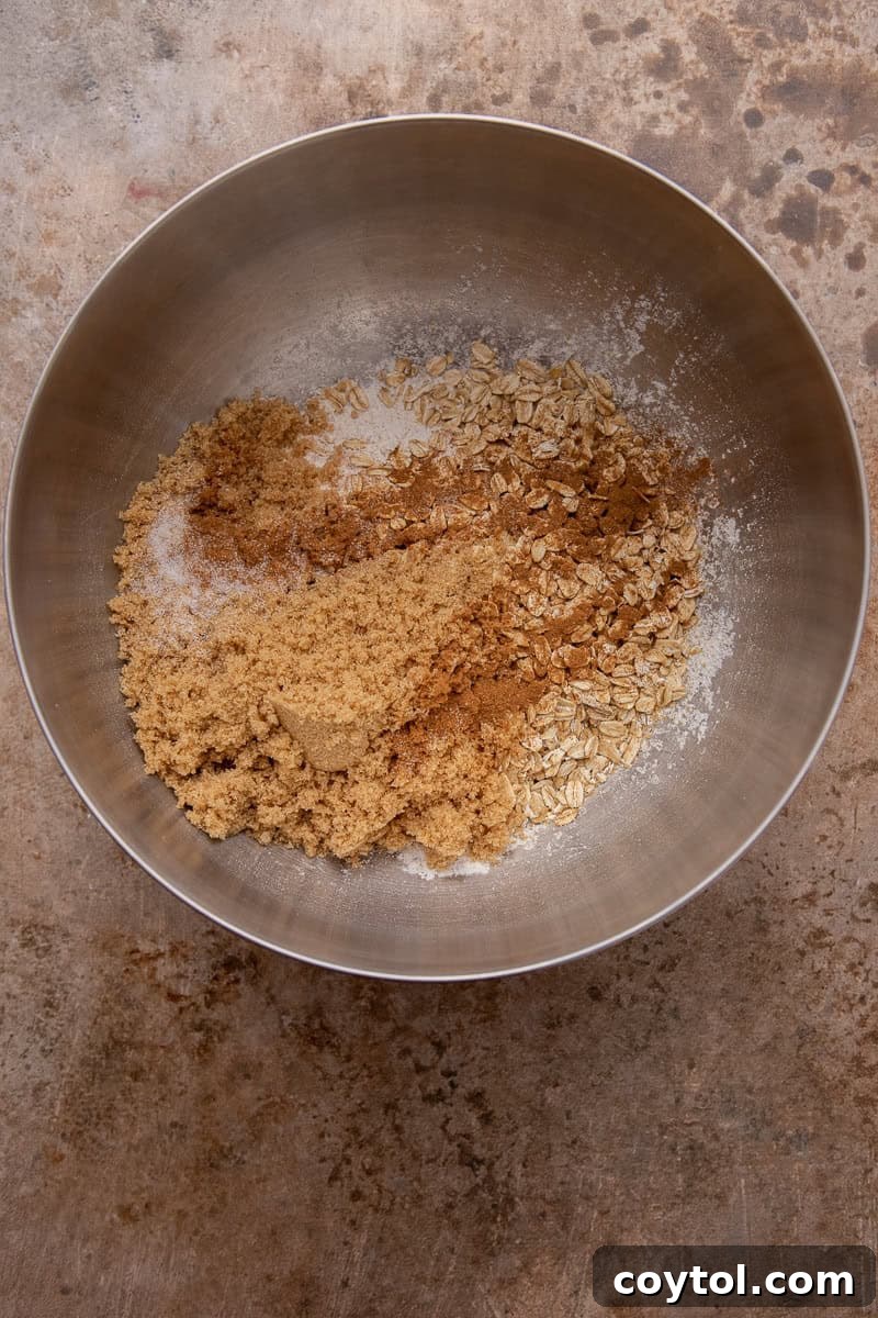 Dry ingredients for the crisp topping, including flour, oats, brown sugar, and spices, mixed in a bowl.