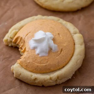 Crumbl's Divine Pumpkin Pie Cookies 12 Crumbl pumpkin pie cookie with a bite taken out of it