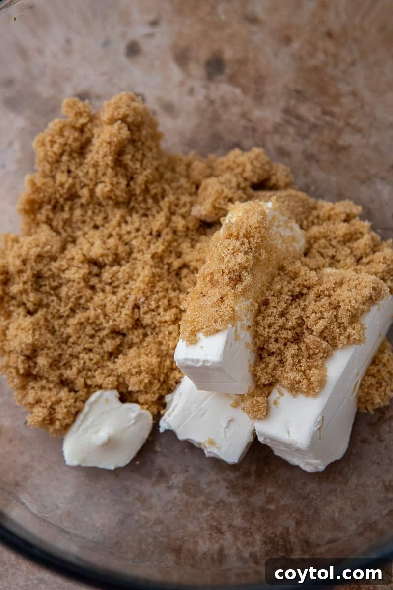Crumbl's Divine Pumpkin Pie Cookies 6 Wet ingredients in a mixing bowl, showcasing the smooth, combined texture.