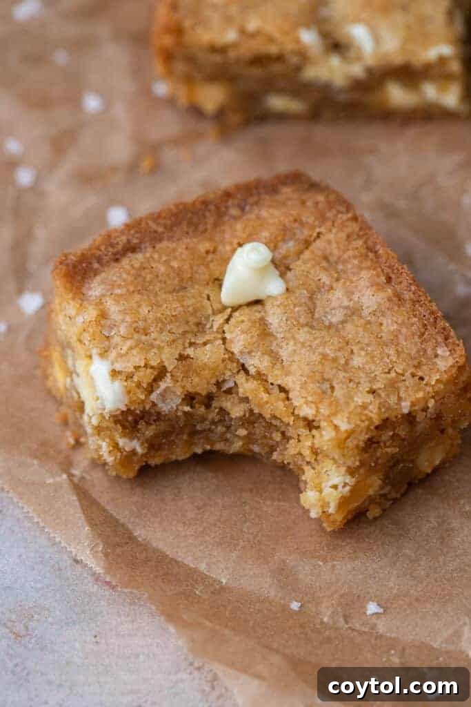 White chocolate blondies slice with a bite taken out of it