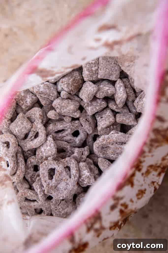 Muddy buddies tossed with powdered sugar in resealable bag