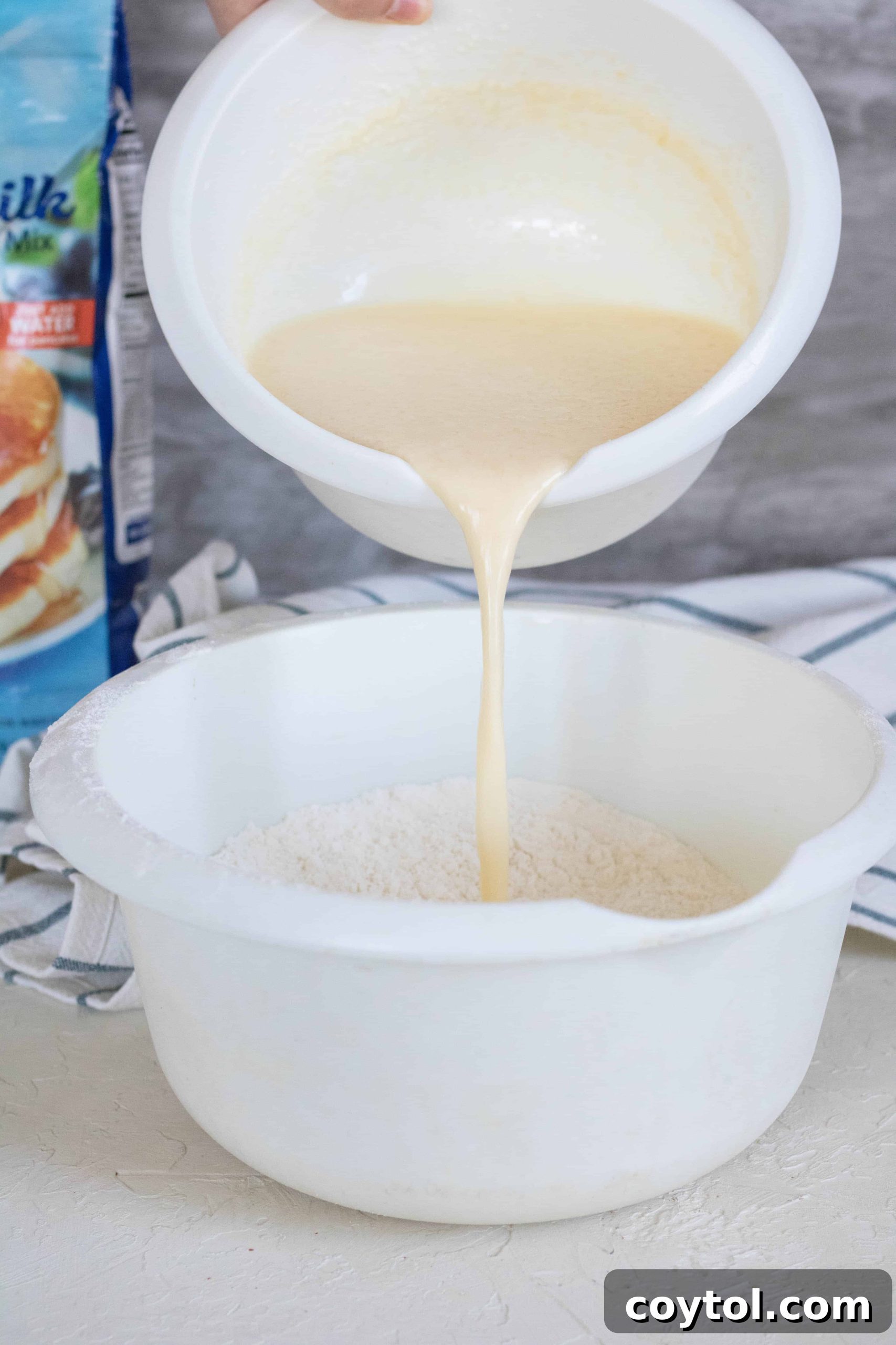 Pouring wet ingredients over the dry ingredients