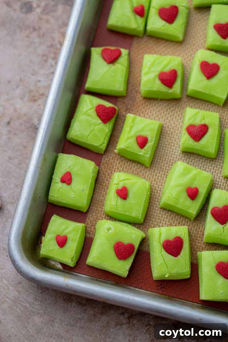 Perfectly sliced Grinch fudge with heart sprinkles