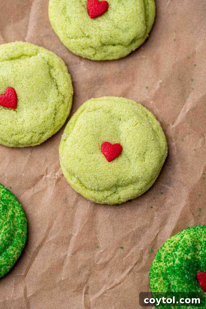 Grinch sugar cookies rolled in granulated sugar, showing a classic sparkly finish.
