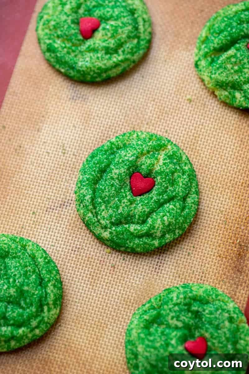 Grinch sugar cookies rolled in green sprinkles, for an extra festive look.
