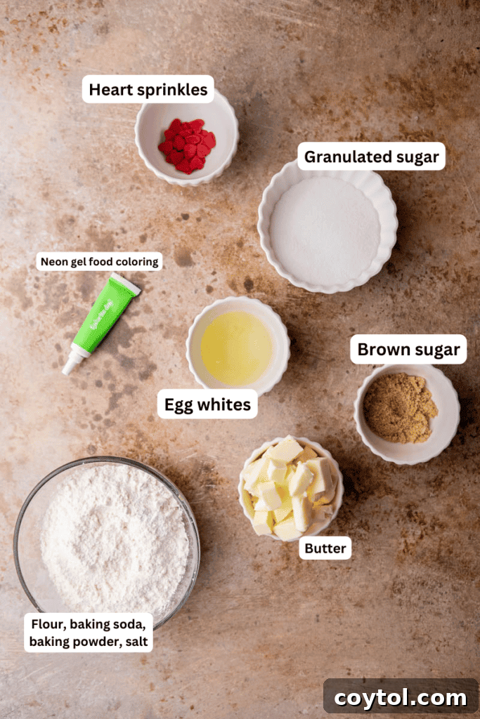 Essential ingredients for Grinch sugar cookies laid out on a kitchen counter: butter, sugars, flour, egg, vanilla, and food coloring.