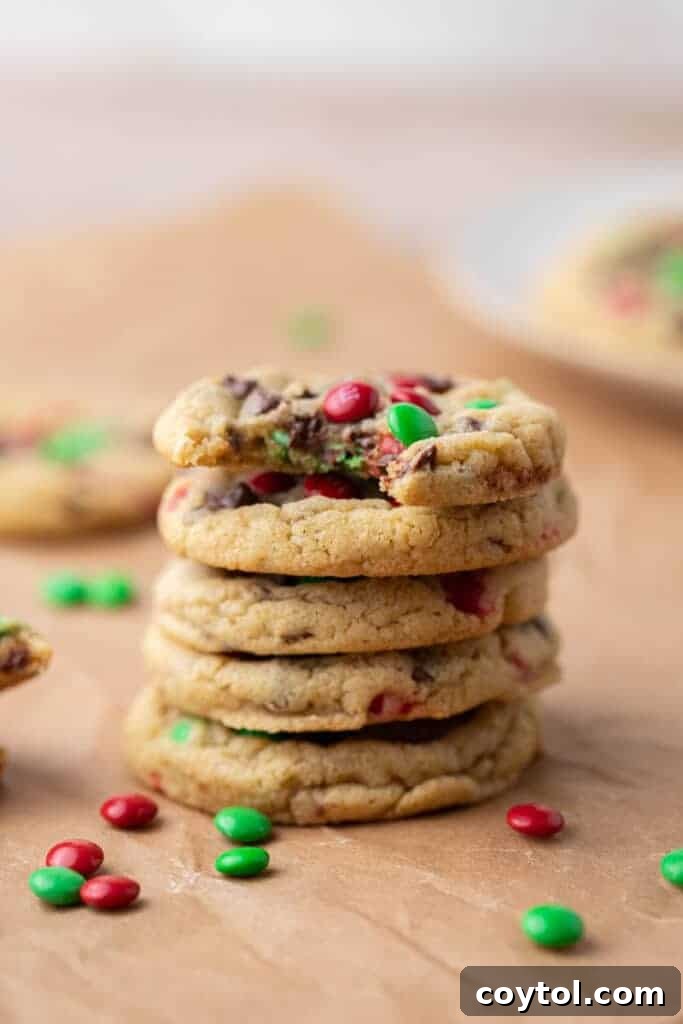 Sparkling Christmas M&Ms Chocolate Chip Cookies 4 A beautiful stack of Christmas M&M chocolate chip cookies on a white plate, ready to be enjoyed