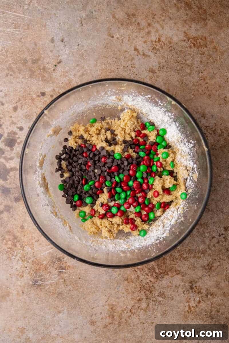 Sparkling Christmas M&Ms Chocolate Chip Cookies 6 Cookie dough with chocolate chips and M&Ms in a bowl, ready to be scooped