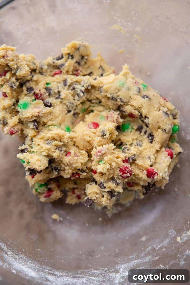 Sparkling Christmas M&Ms Chocolate Chip Cookies 7 Close-up of M&M cookie dough being folded