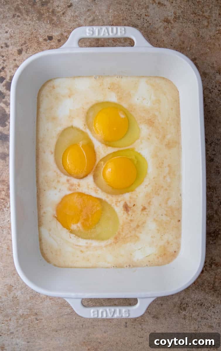 Wet ingredients for french toast custard being whisked in a shallow pan.
