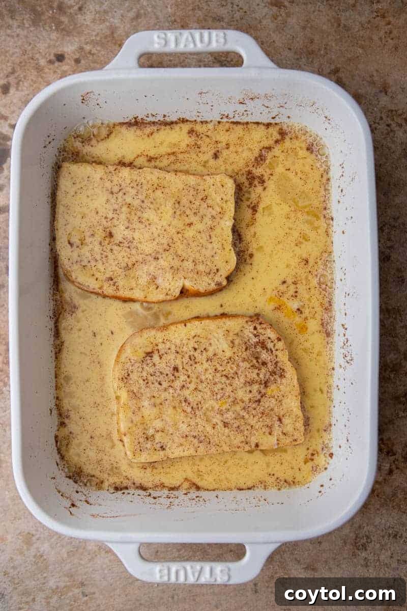 Another view of brioche bread soaking in the custard, ready to be cooked.
