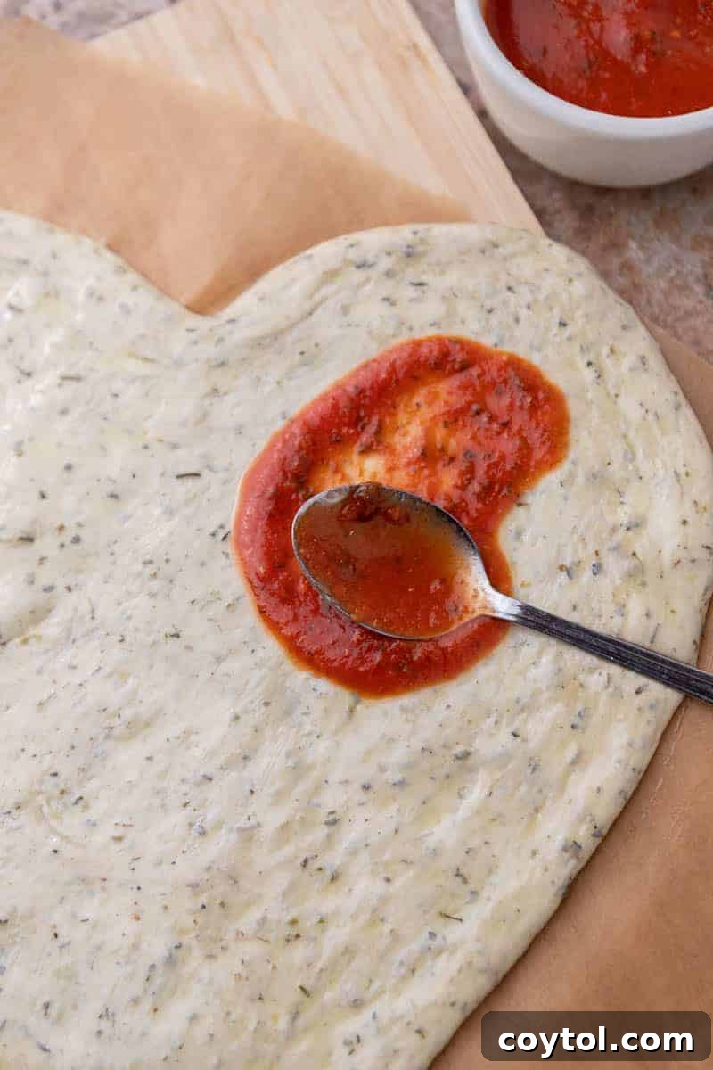 Love-Struck Pizza: Valentine's Heart Recipe 8 spread tomato sauce on pizza