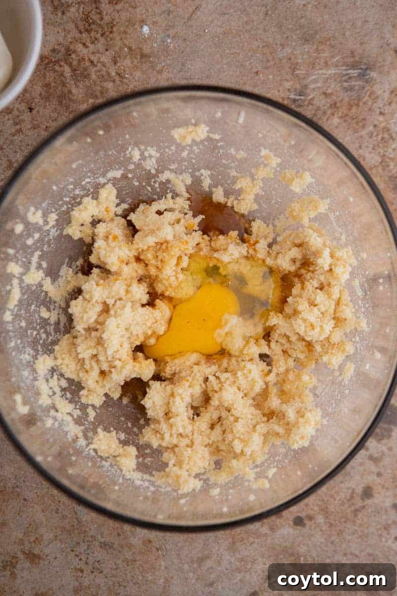 Divine Crumbl Lemon Cheesecake Cookies 4 Creamed butter and sugar in a mixing bowl, ready for the next step of adding eggs.
