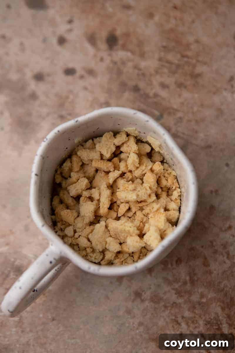 Golden Oreo Gooey Mug Cake in Minutes 4 Crushed golden oreos in a microwave-safe mug