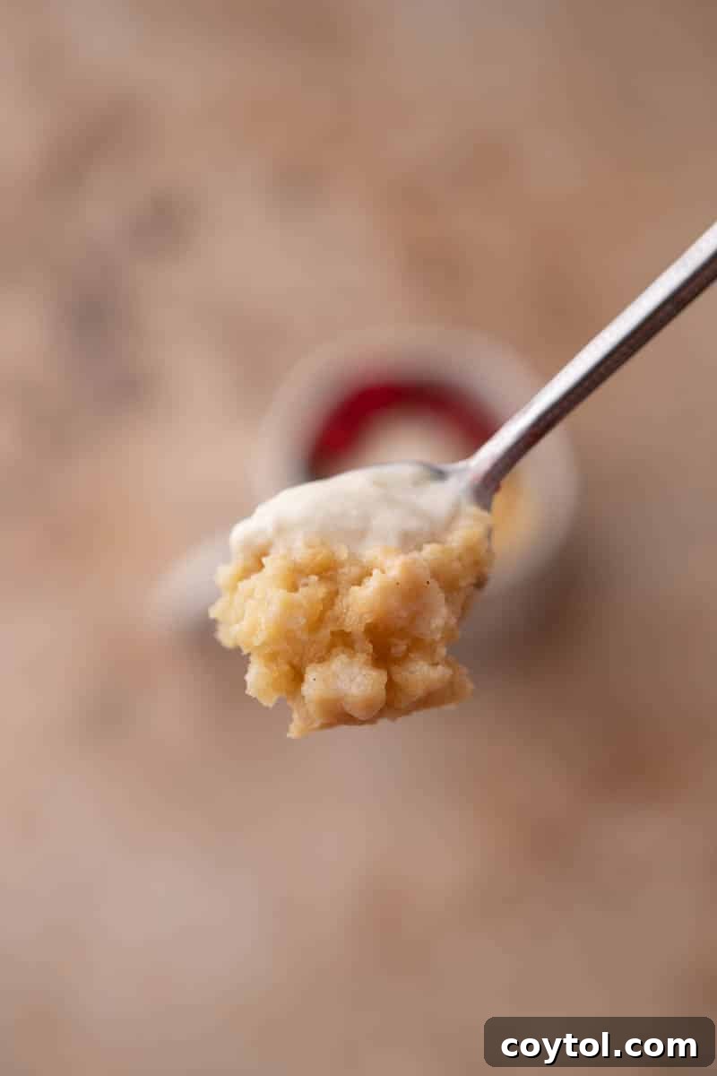 Golden Oreo Gooey Mug Cake in Minutes 7 A spoonful of molten golden oreo mug cake with a creamy center