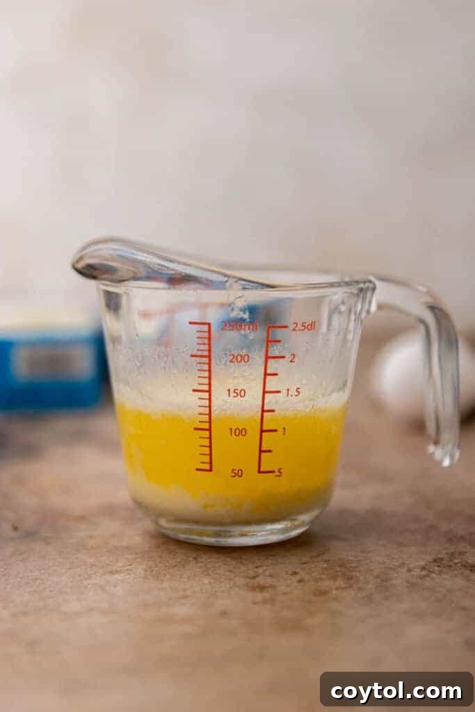 Melted butter in a glass measuring cup, ready to enhance cornbread mix