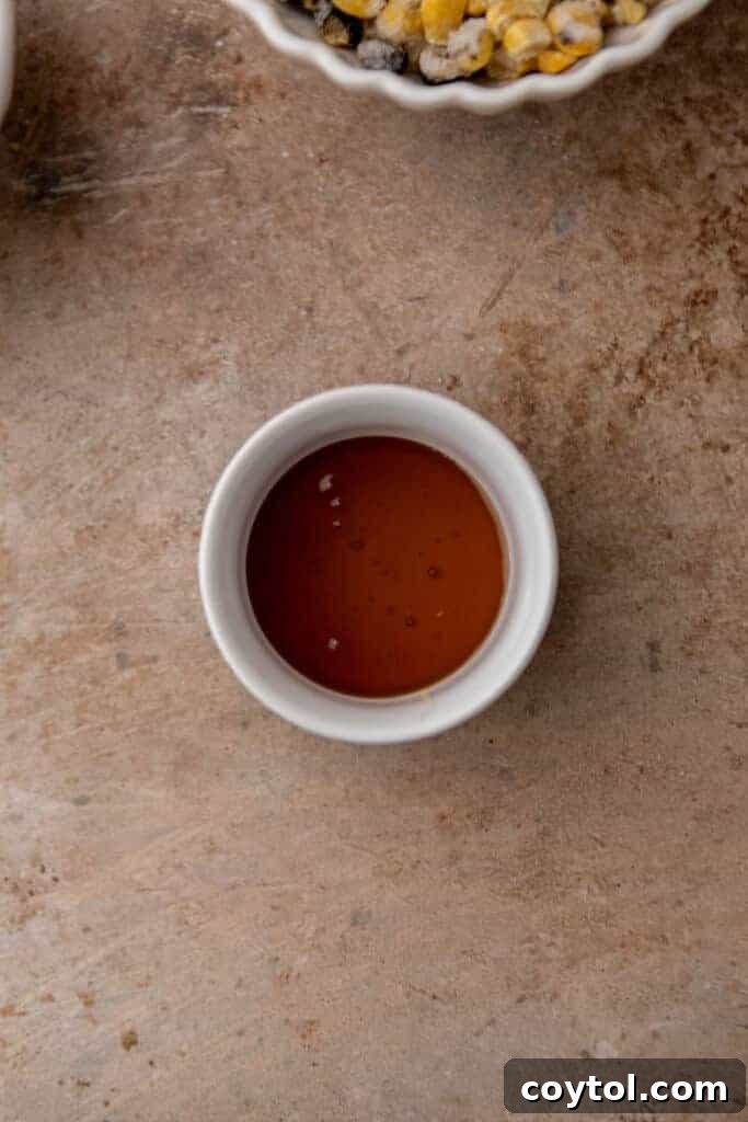 Honey in a container, a sweet addition for doctored up cornbread