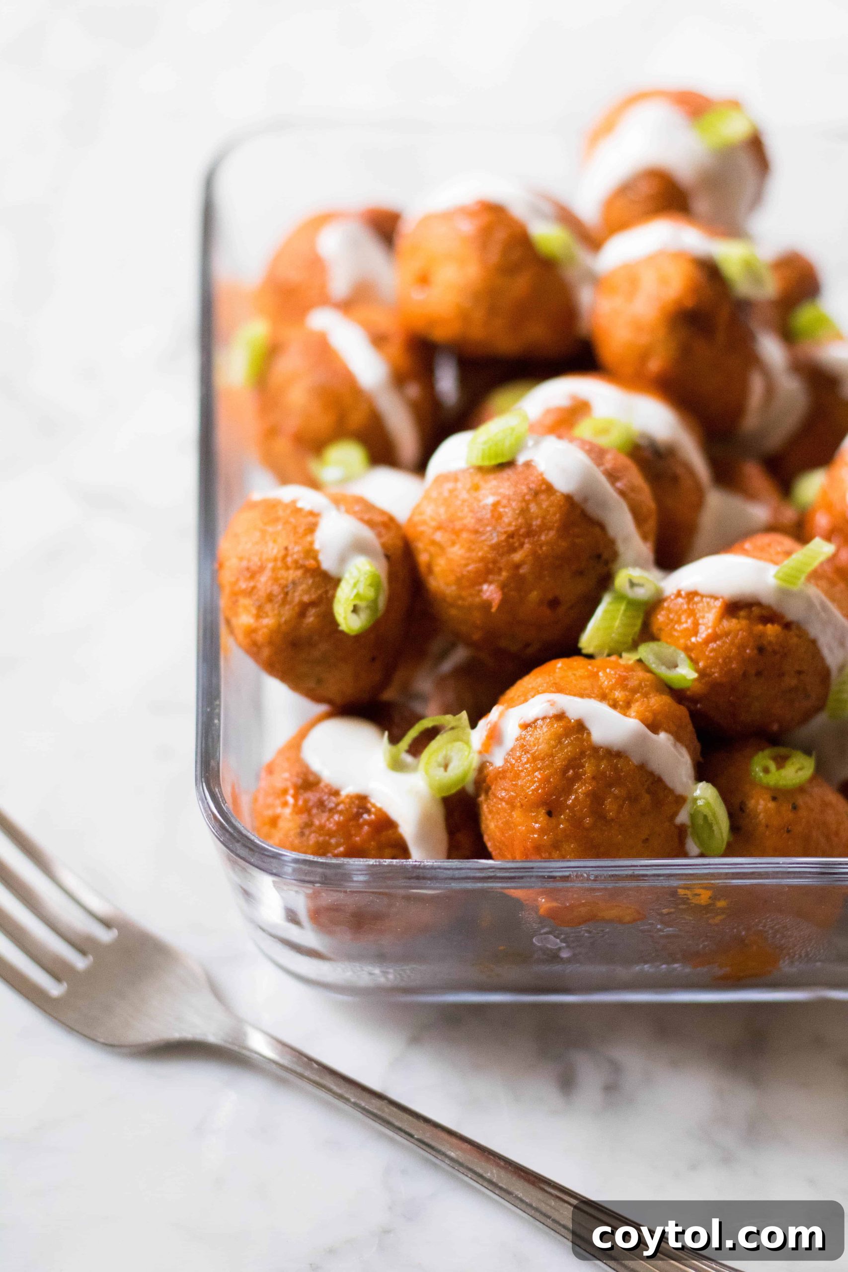 Guilt-Free Baked Buffalo Chicken Meatballs 2 Container of healthy baked buffalo chicken meatballs.