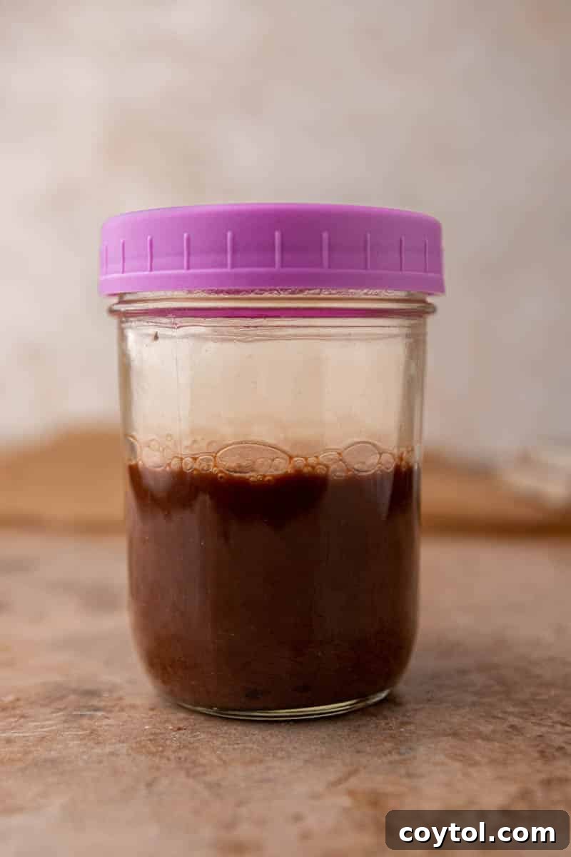 Shaken cold brew with chocolate sauce in a mason jar, ready to be poured