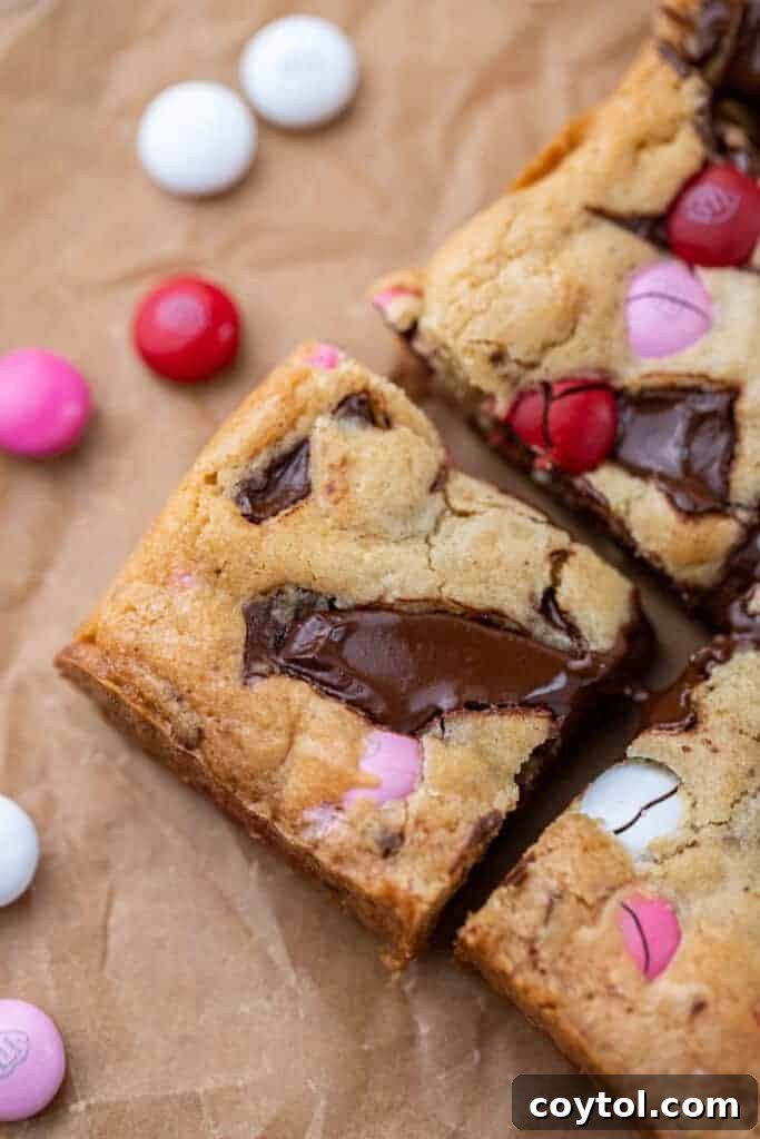 Sweet & Simple Valentine M&M Blondies 2 Close-up of a stack of Valentine's day m&m's blondies with pink, red, and white candies.