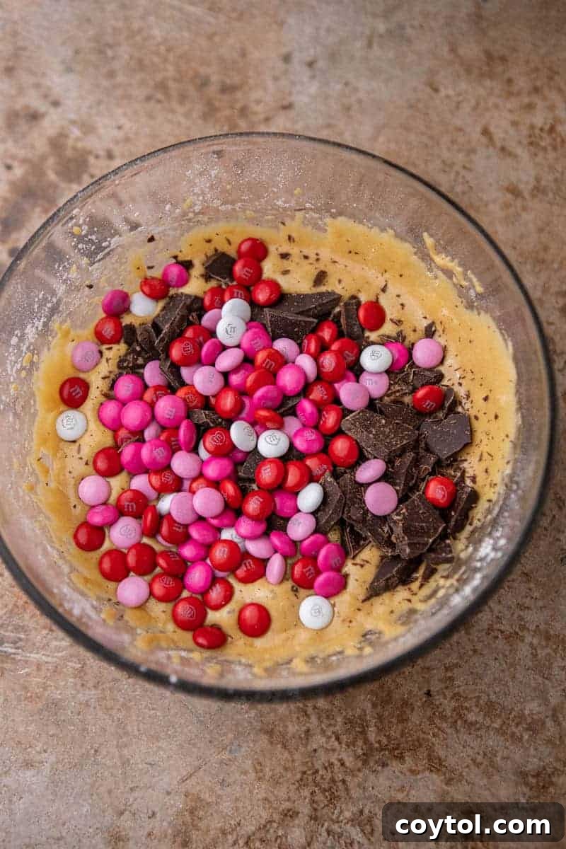 Sweet & Simple Valentine M&M Blondies 6 Blondie batter with M&M's and chocolate chunks folded in, ready for baking.