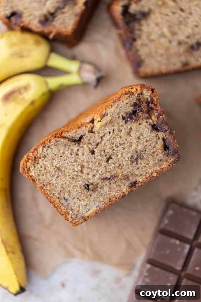 A whole loaf of golden-brown eggless banana bread, fresh out of the oven, exuding warmth and deliciousness.
