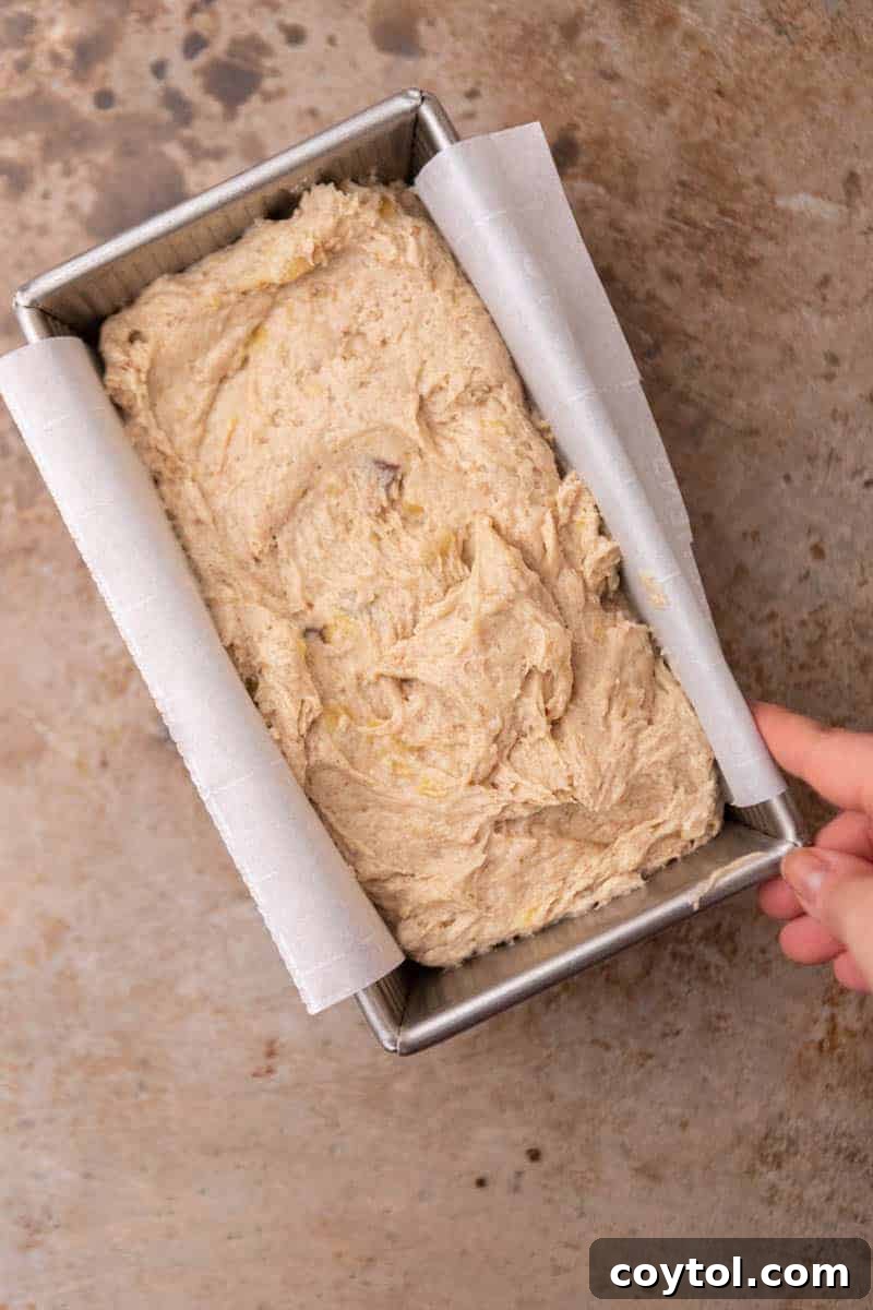 Eggless banana bread batter poured into a loaf pan, ready for baking.