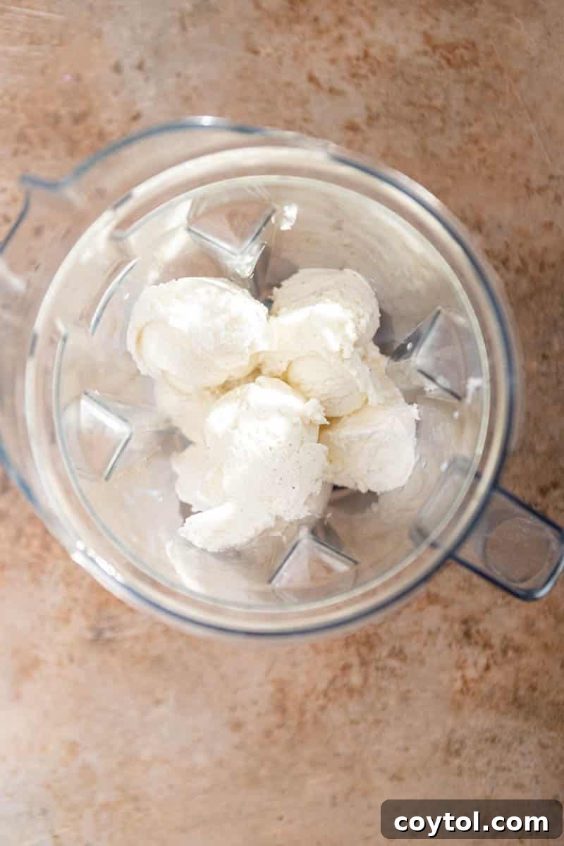Ice cream, cool whip, and milk in a blender cup, ready to be blended for McFlurry.