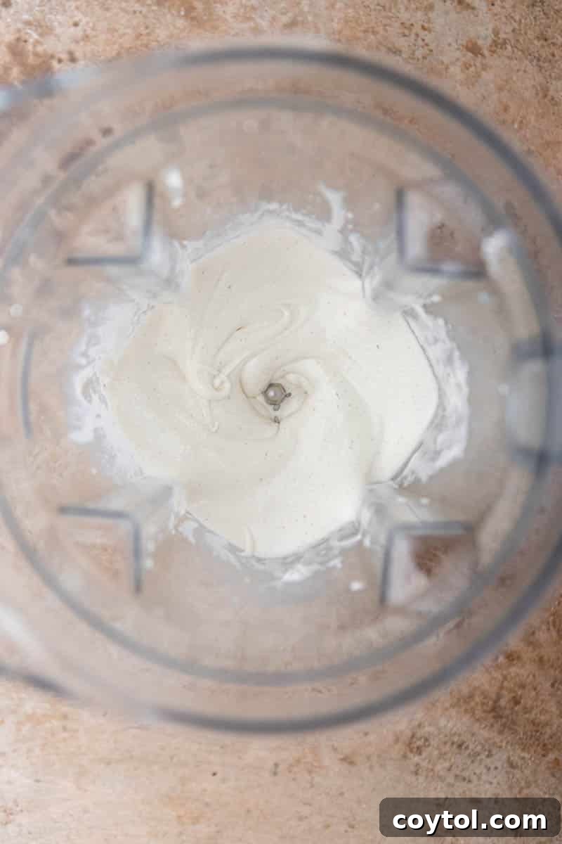 Whipped and creamy ice cream base in a blender, showing perfect soft-serve texture.
