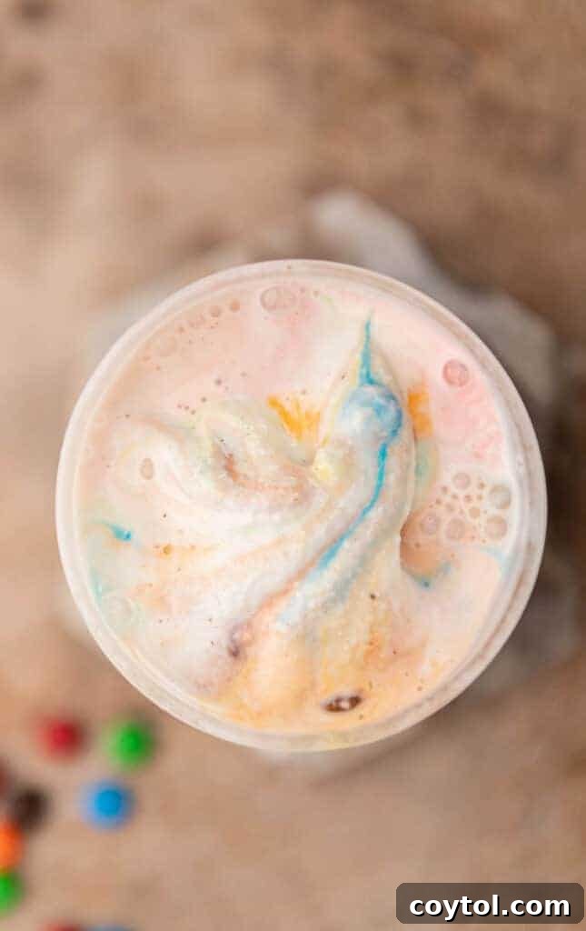 Overhead shot of a M&M's McFlurry in a clear glass cup.