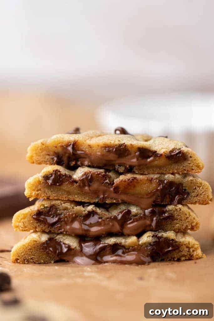 Stack of chocolate stuffed chocolate chip cookies on a plate
