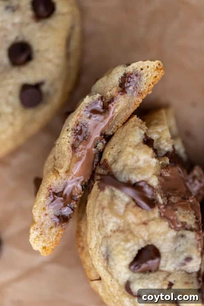 Close-up of a chocolate stuffed chocolate chip cookie showing the melted chocolate oozing out