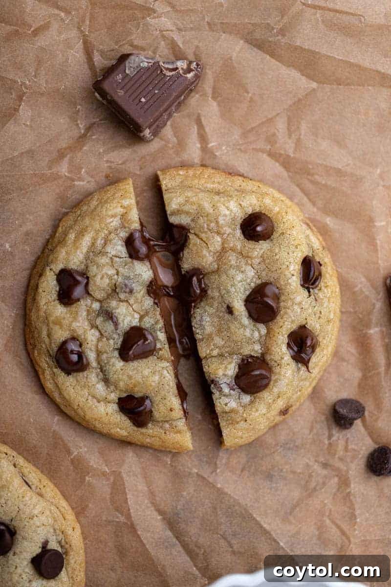 Chocolate oozing out of a warm chocolate chip cookie