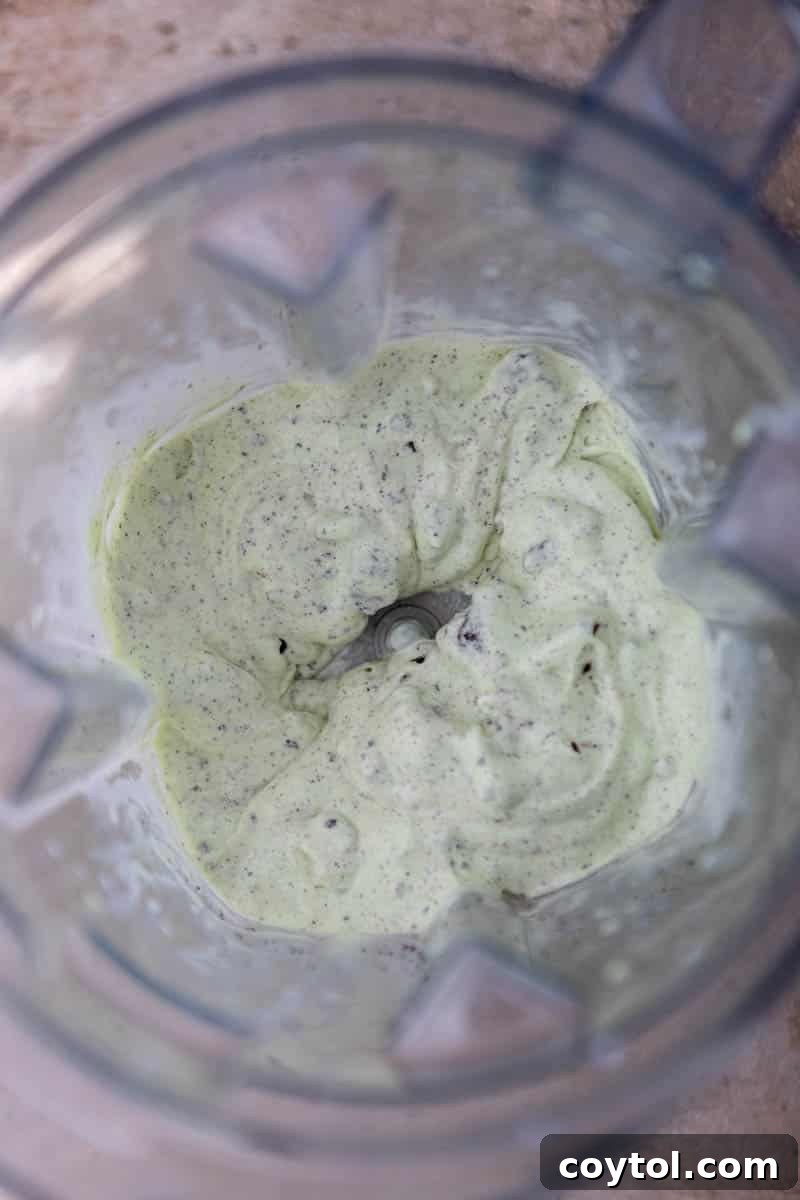 Blender mixing a vibrant green McFlurry mixture.