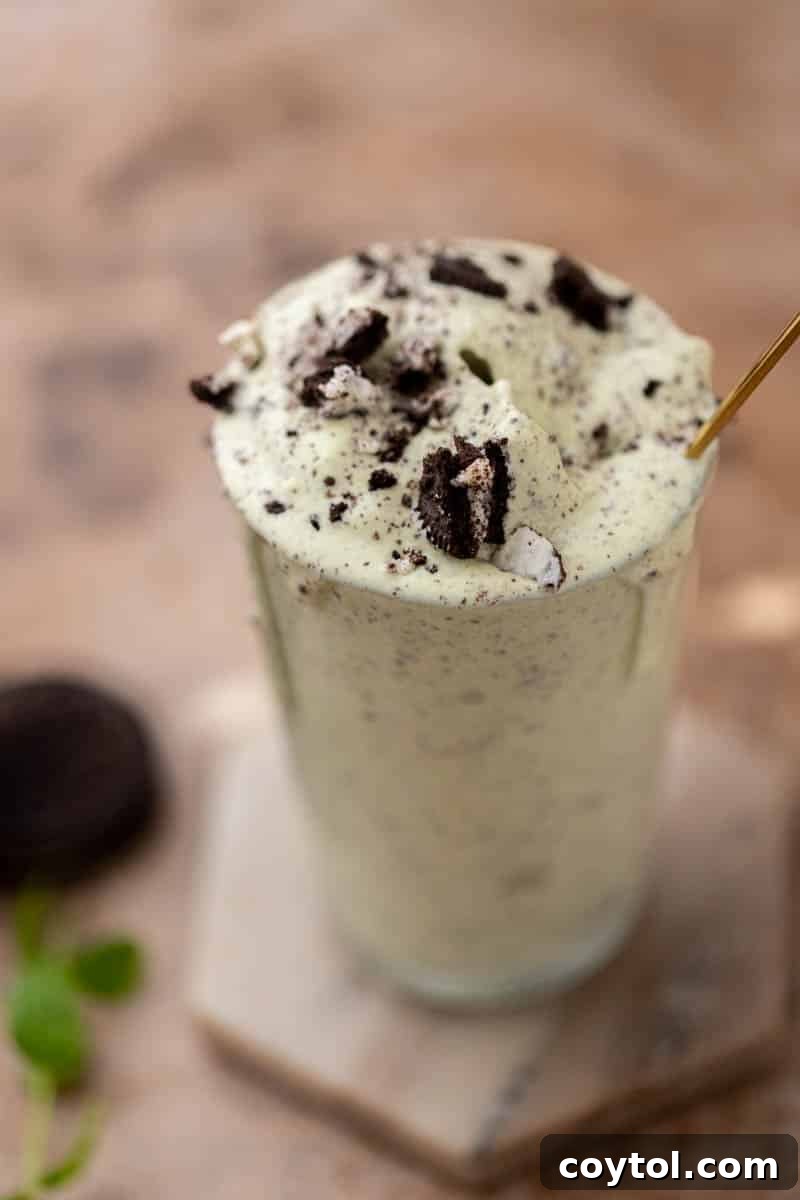 A freshly blended Oreo Shamrock McFlurry served in a glass.