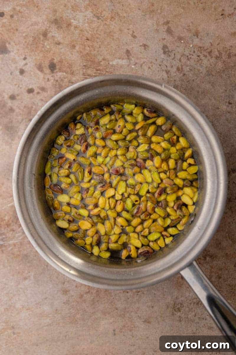Starbucks Pistachio Coffee Delight 4 Pistachios simmering in syrup in a saucepan