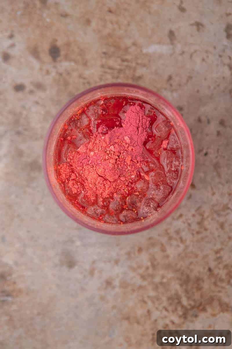Homemade Starbucks Strawberry Acai Refresher Recipe 4 Ingredients in a measuring cup ready to be mixed