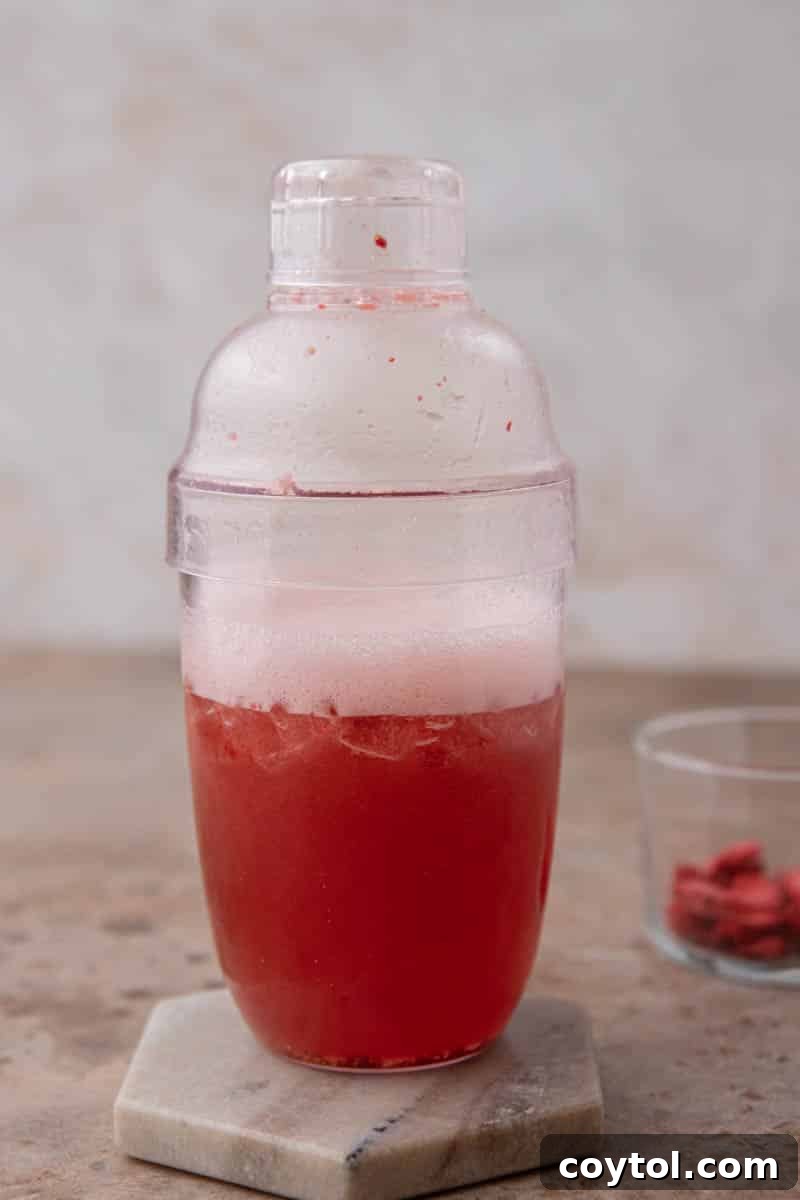 Homemade Starbucks Strawberry Acai Refresher Recipe 5 Mixture being shaken in a shaker cup