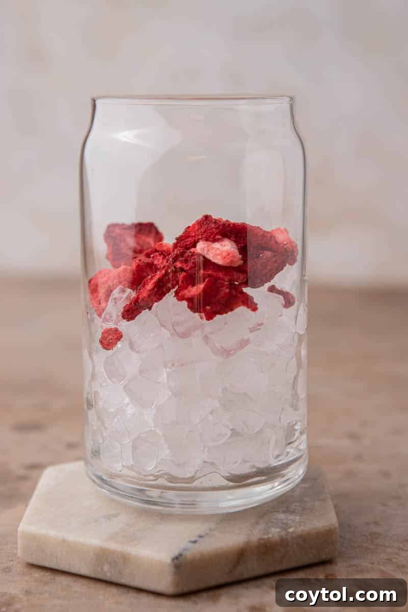 Homemade Starbucks Strawberry Acai Refresher Recipe 6 Glass filled with ice and freeze-dried strawberries