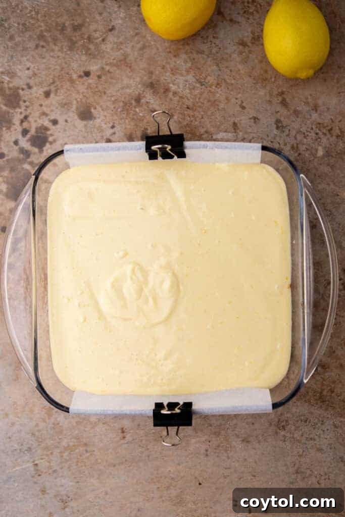 Lemon bar filling on top of the crust
