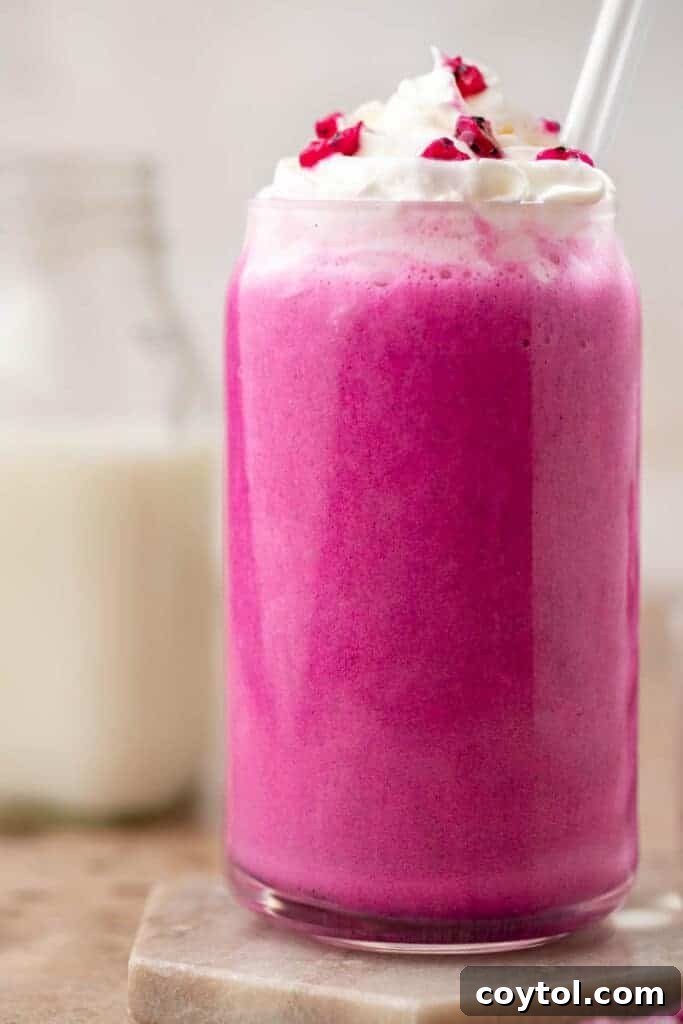 Close-up of a Starbucks Barbie frappuccino with whipped cream and dragon fruit