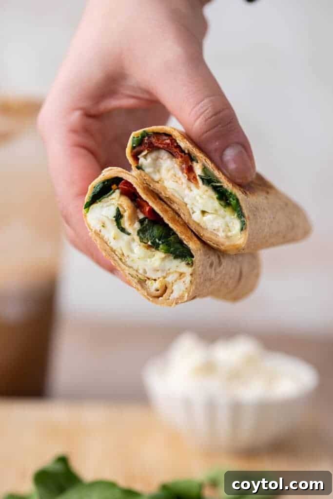 Homemade Starbucks Spinach Feta Wrap 2 Hand holding Starbucks style spinach feta wrap