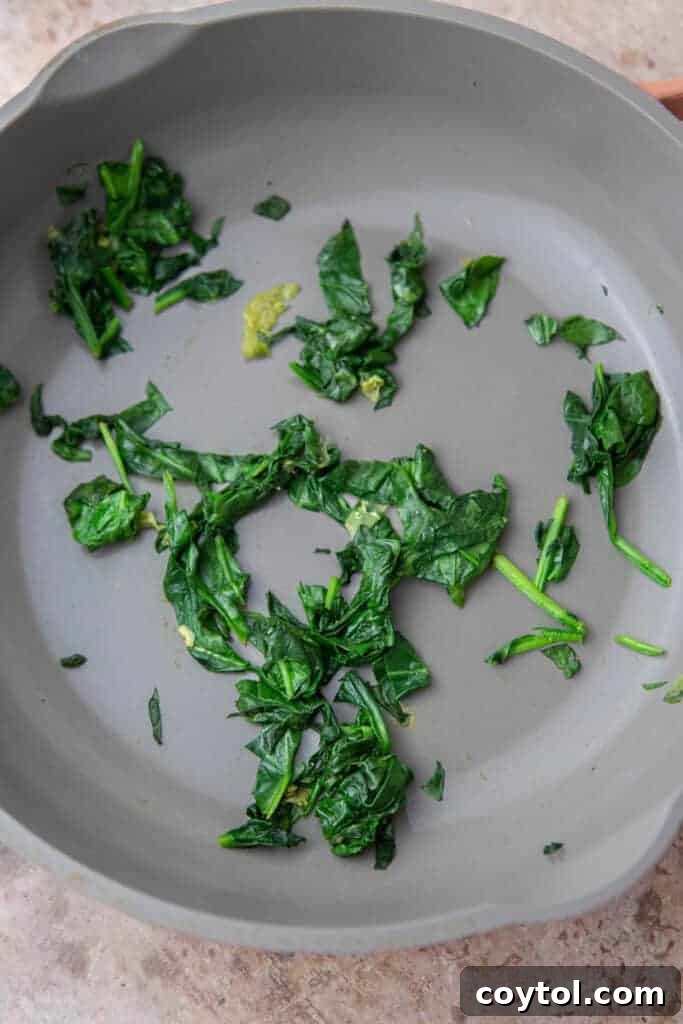 Homemade Starbucks Spinach Feta Wrap 6 Spinach cooked in a pan for the wrap