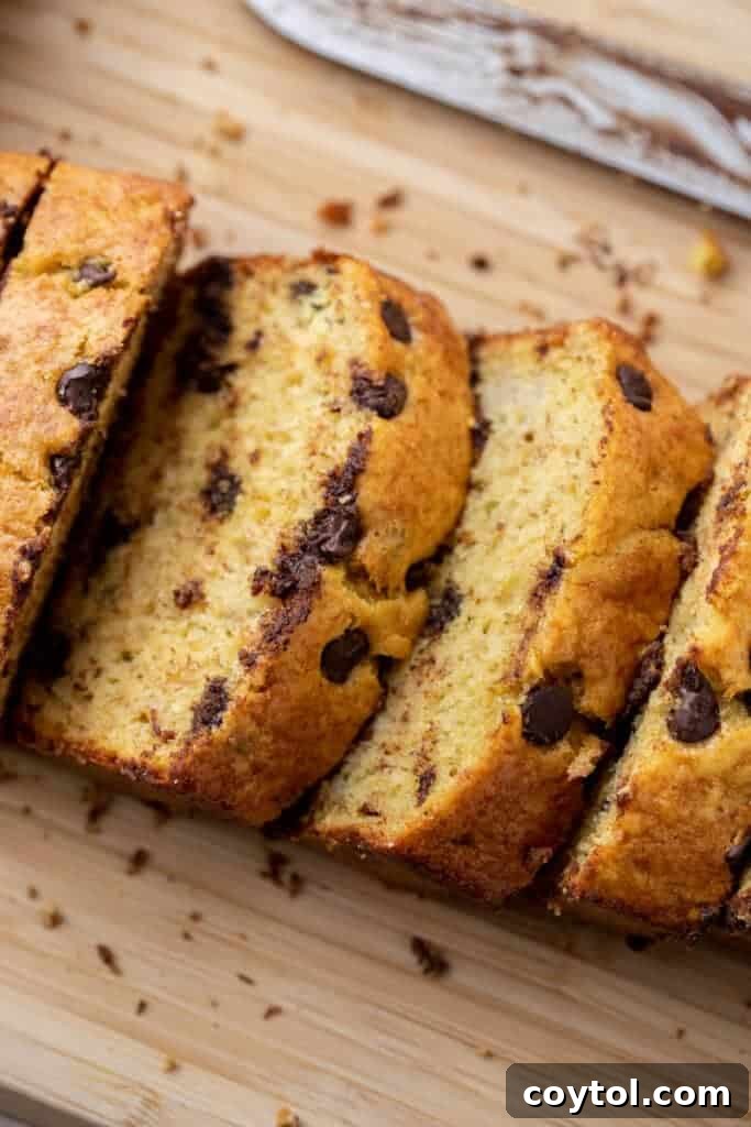 Moist slices of cake mix banana bread with chocolate chips on a wooden board.