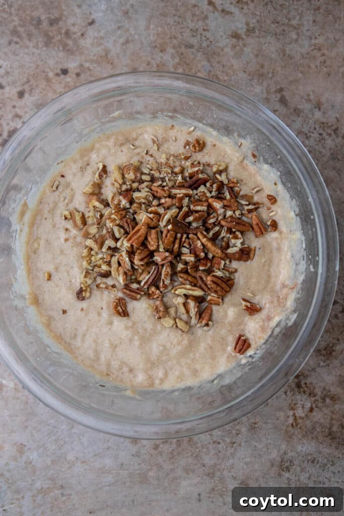 Banana bread batter with nuts in a bowl