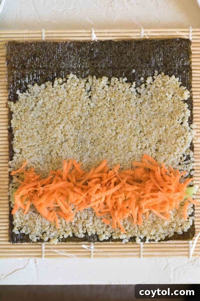 Crafting Vibrant Veggie Quinoa Sushi 11 Carrot strips being added to the quinoa sushi filling.